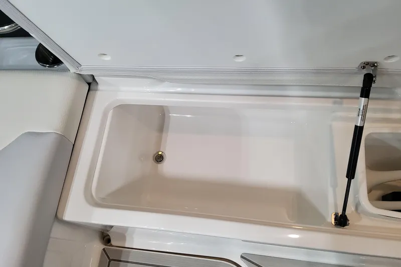 Slide: The Image of Storage compartment in 2026 Formula 330 Crossover Bowrider OB boat, featuring hydraulic lift support. - 65