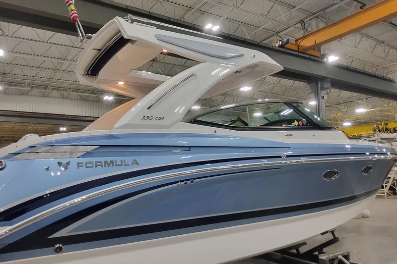 Slide: The Image of 2026 Formula 330 Crossover Bowrider OB in a showroom, showcasing sleek design and modern features. - 8