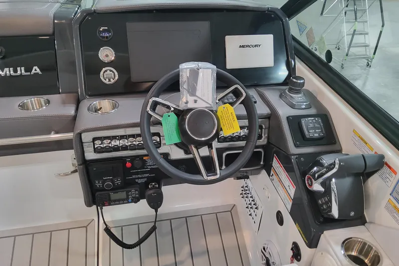 Slide: The Image of 2026 Formula 330 Crossover Bowrider OB helm with advanced controls and Mercury display. - 81