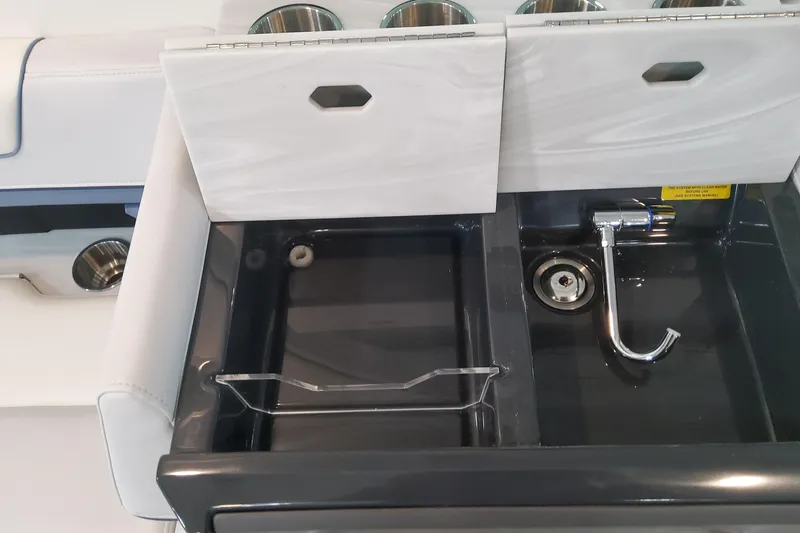 Slide: The Image of 2026 Formula 330 Crossover Bowrider OB sink and storage area with modern design. - 86