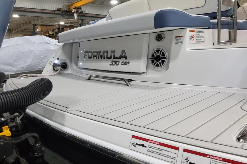 Slide: The Image of 2026 Formula 330 Crossover Bowrider OB boat deck with branding and safety warnings. - 9
