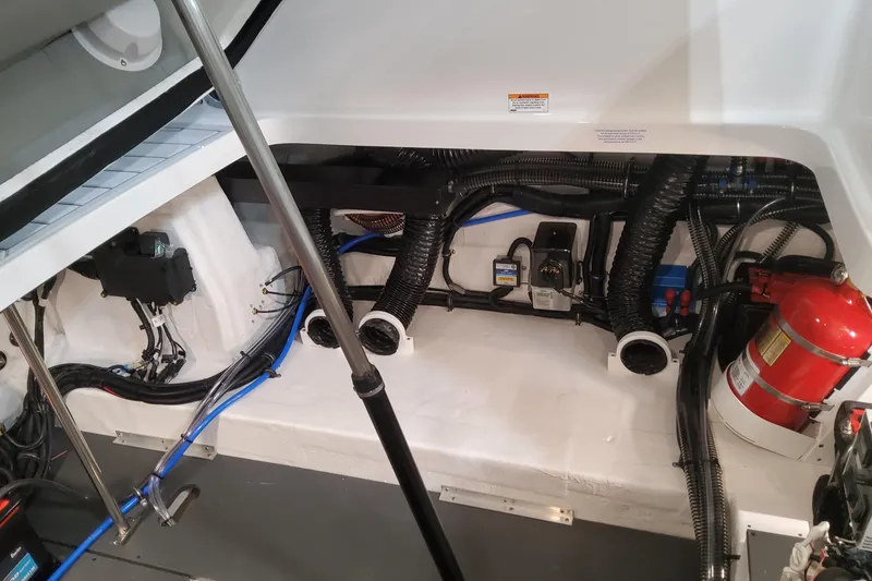 Slide: The Image of Engine compartment of 2026 Formula 330 Crossover Bowrider OB with fire extinguisher and wiring. - 95