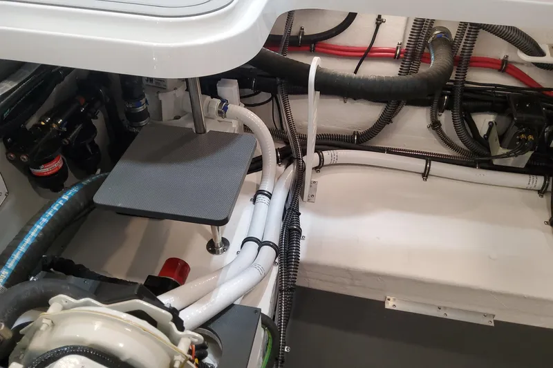 Slide: The Image of Engine compartment of 2026 Formula 330 Crossover Bowrider OB, showcasing hoses and wiring. - 97