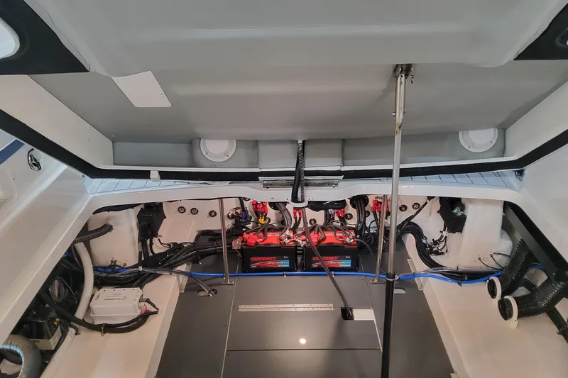 Slide: The Image of Engine compartment of 2026 Formula 330 Crossover Bowrider OB, showcasing batteries and wiring. - 99