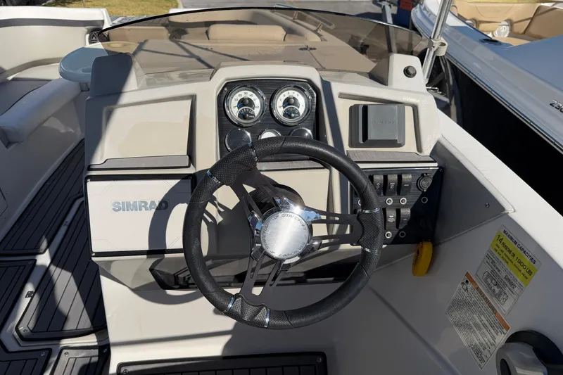 Slide: The Image of 2023 Starcraft SVX 231 OB boat dashboard with steering wheel and controls. - 10