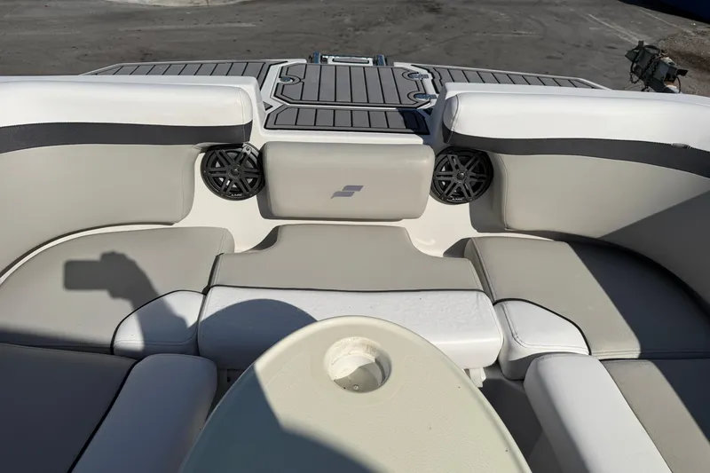 Slide: The Image of 2023 Starcraft SVX 231 OB boat interior with cushioned seating and speakers. - 13