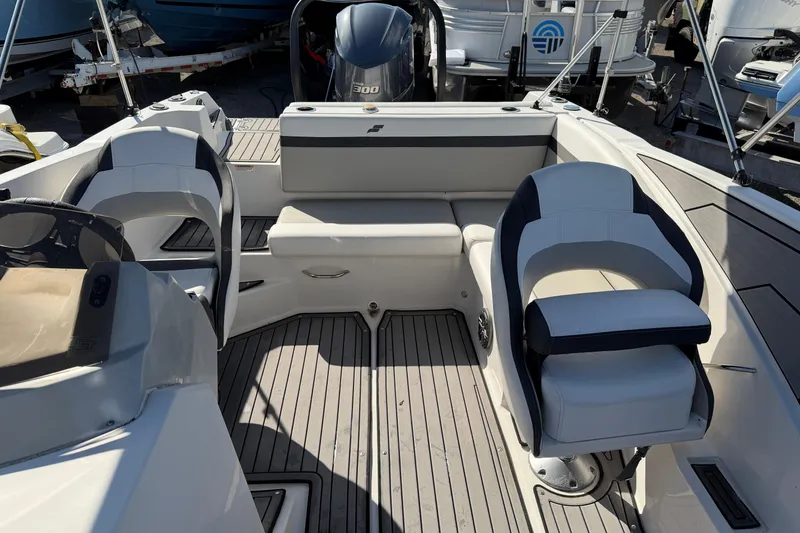 Slide: The Image of 2023 Starcraft SVX 231 OB boat interior with seating and outboard motor. - 14