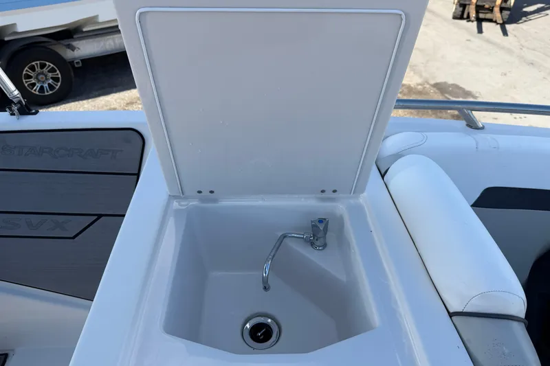 Slide: The Image of 2023 Starcraft SVX 231 OB boat sink with faucet and storage compartment. - 16