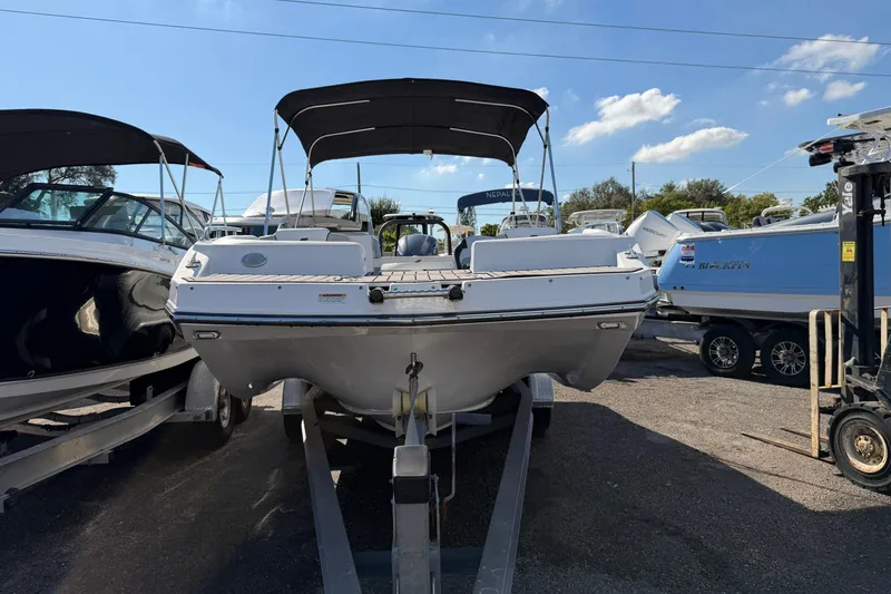 Slide: The Image of 2023 Starcraft SVX 231 OB boat on trailer under clear blue sky. - 3