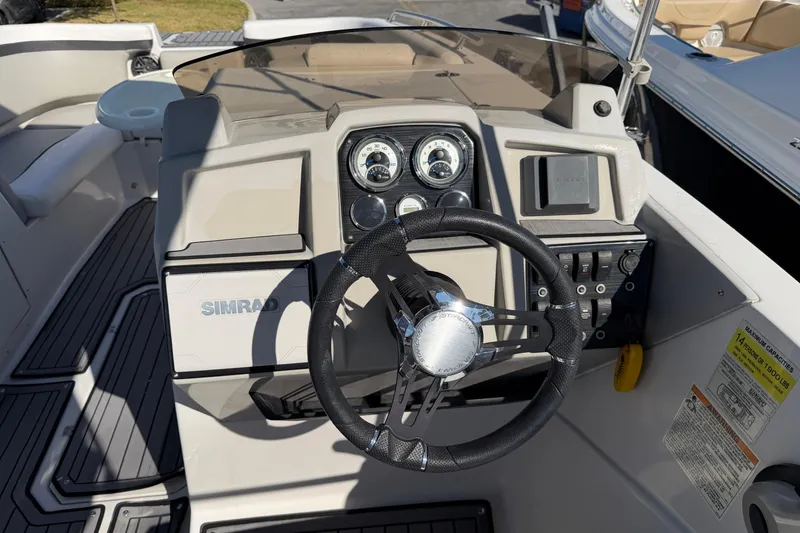 Slide: The Image of 2023 Starcraft SVX 231 OB boat dashboard with steering wheel and controls. - 9
