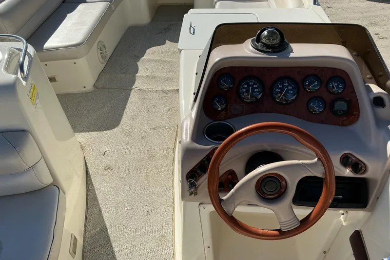Slide: The Image of 1997 Monterey 233 Explorer boat interior with steering wheel and instrument panel. - 7
