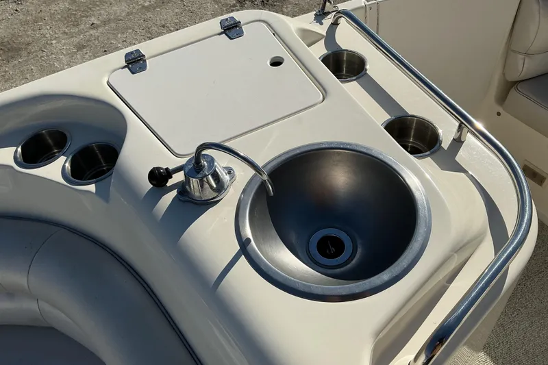 Slide: The Image of 1997 Monterey 233 Explorer boat sink and cup holders on deck. - 8