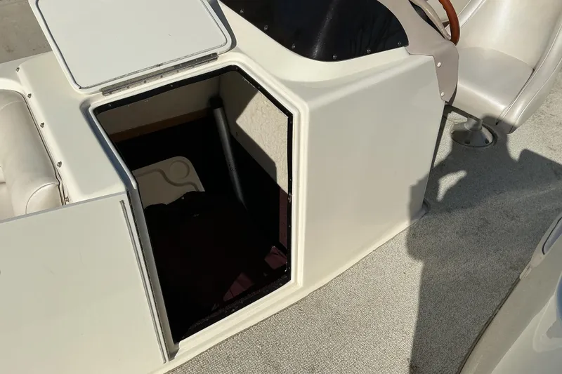 Slide: The Image of Open storage compartment on a 1997 Monterey 233 Explorer boat deck. - 9