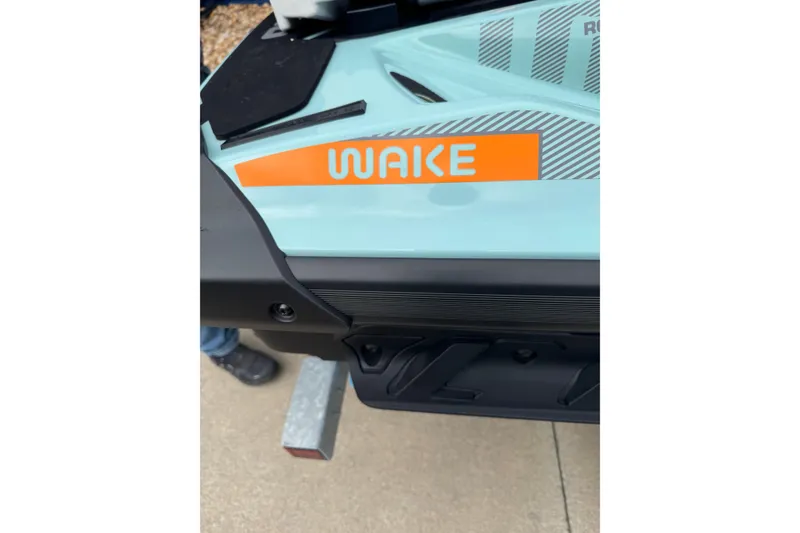 Slide: The Image of 2024 Sea Doo Wake 170 close-up, showcasing the "Wake" branding on the side. - 15