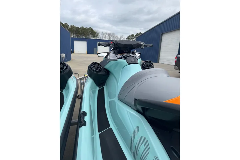 Slide: The Image of 2024 Sea Doo Wake 170 jet ski in a parking area, showcasing sleek design and controls. - 6