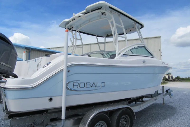 Slide: The Image of 2018 Robalo R247 Dual Console boat on trailer, side view. - 1
