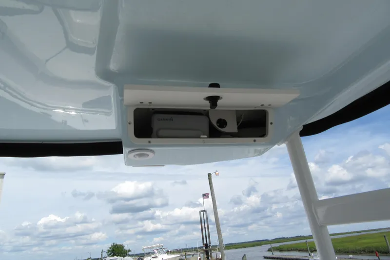 Slide: The Image of 2018 Robalo R247 Dual Console boat with Garmin equipment, docked under a cloudy sky. - 11