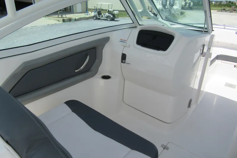 Slide: The Image of 2018 Robalo R247 Dual Console interior with seating and storage compartment. - 6