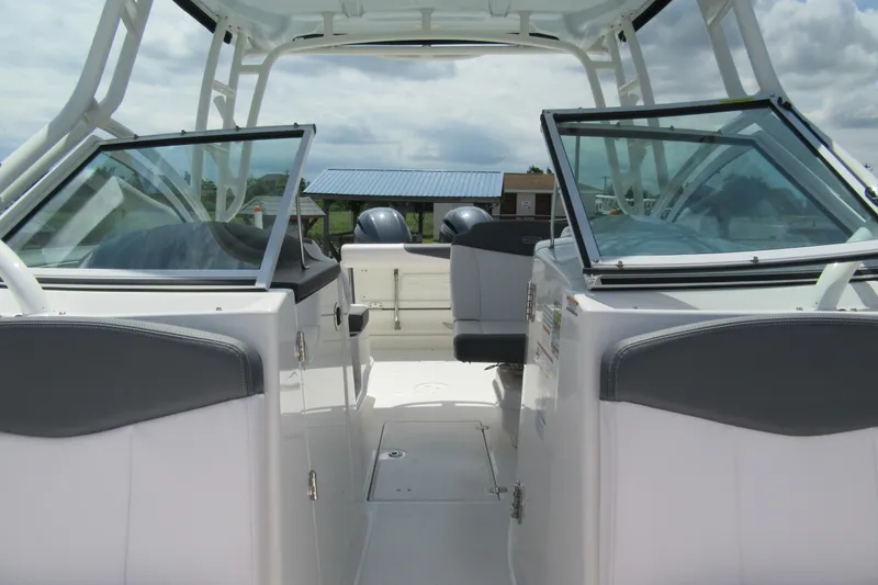 Slide: The Image of 2018 Robalo R247 Dual Console boat interior with seating and windshield. - 7