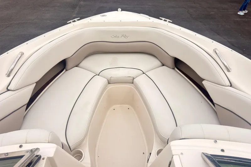 Slide: The Image of 2003 Sea Ray 240 Bow Rider boat interior with white cushioned seating. - 4