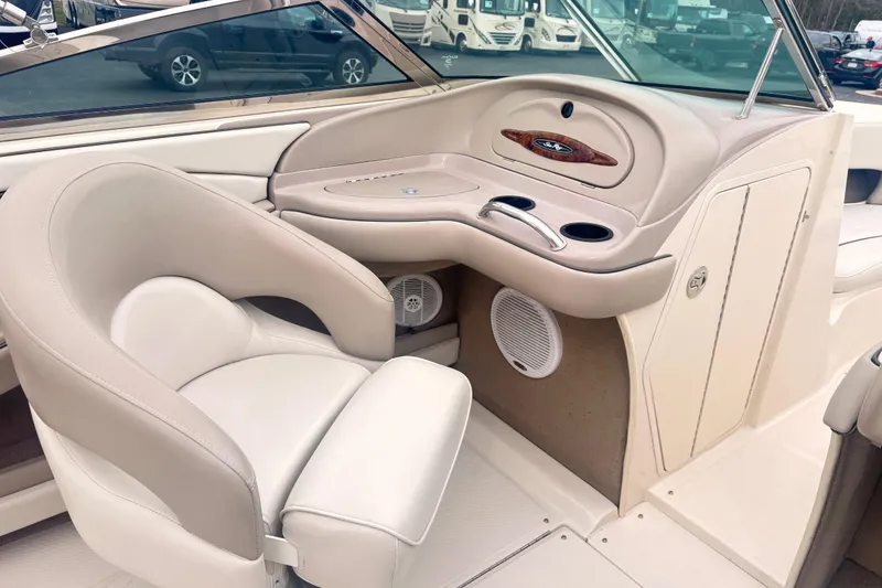 Slide: The Image of Interior of 2003 Sea Ray 240 Bow Rider boat with beige seating and dashboard. - 6