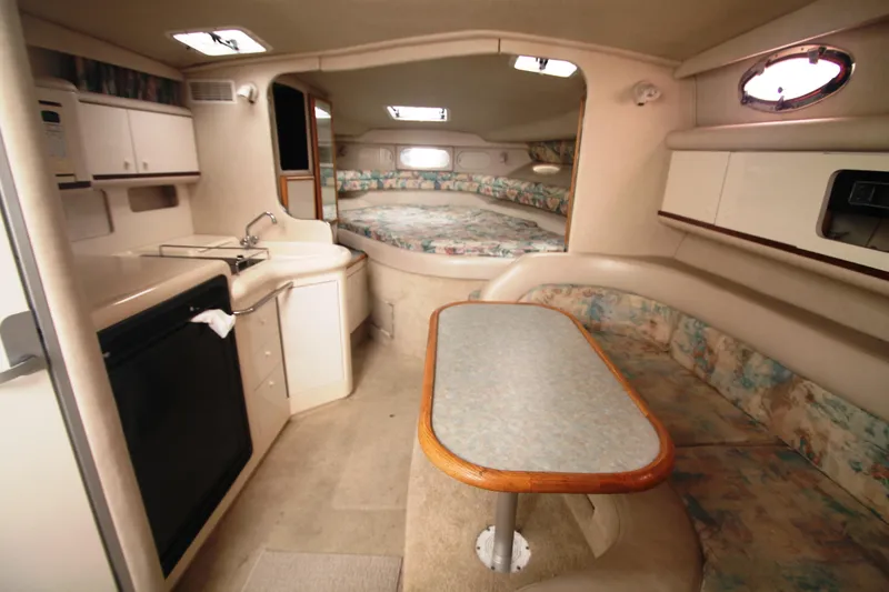 The Image of Interior of 1996 Sea Ray Sundancer 330 yacht with kitchenette and seating area. - 1