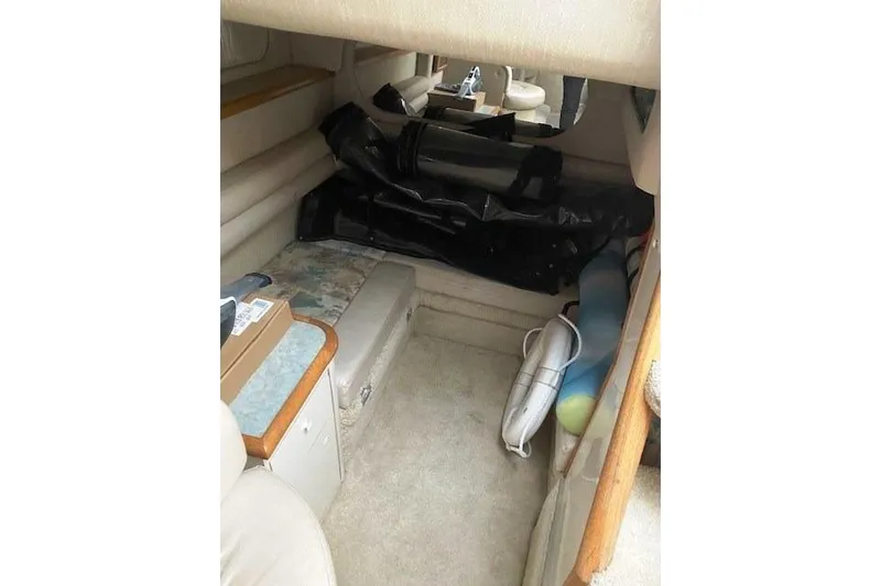 Slide: The Image of Interior cabin of a 1996 Sea Ray Sundancer 330 boat, featuring seating and storage. - 14