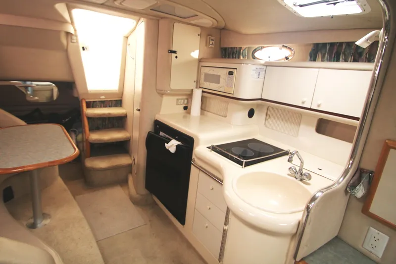 Slide: The Image of Interior of 1996 Sea Ray Sundancer 330 yacht with kitchenette and dining area. - 16
