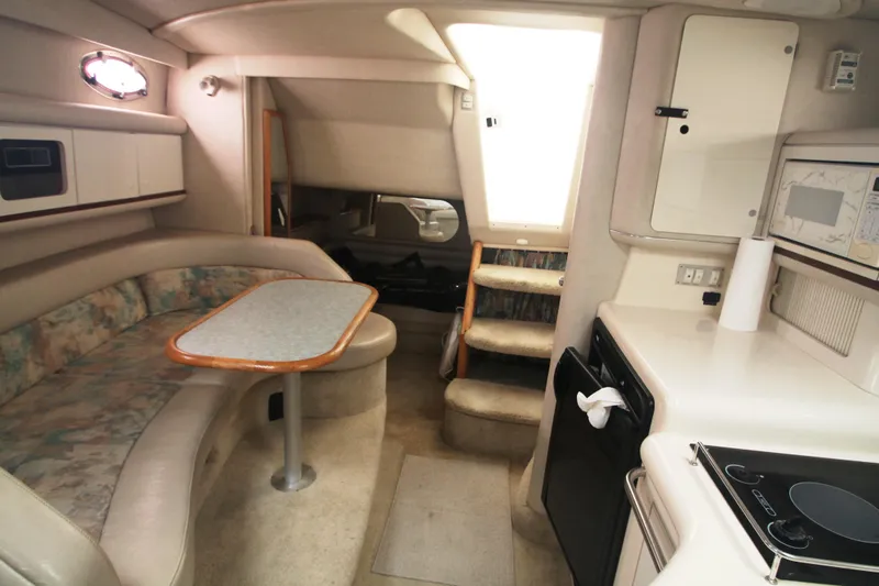 Slide: The Image of Interior of 1996 Sea Ray Sundancer 330 yacht with kitchenette and seating area. - 2