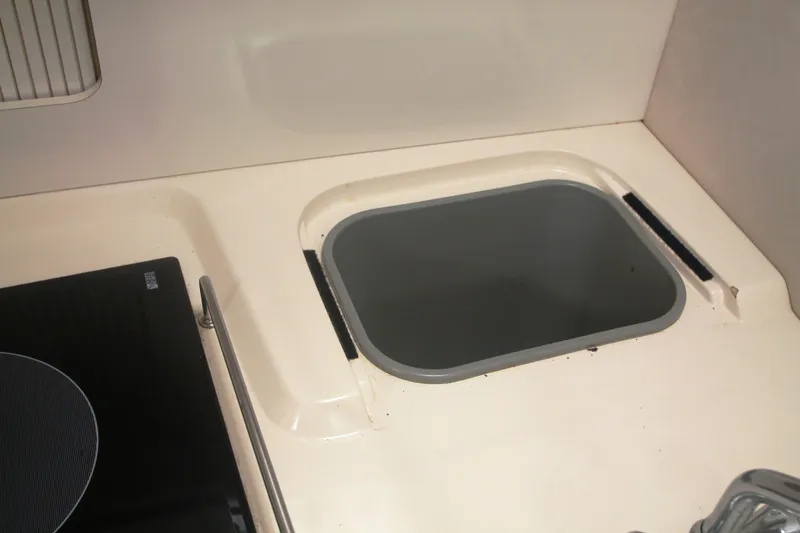 Slide: The Image of Kitchen sink area in a 1996 Sea Ray Sundancer 330 boat. - 20