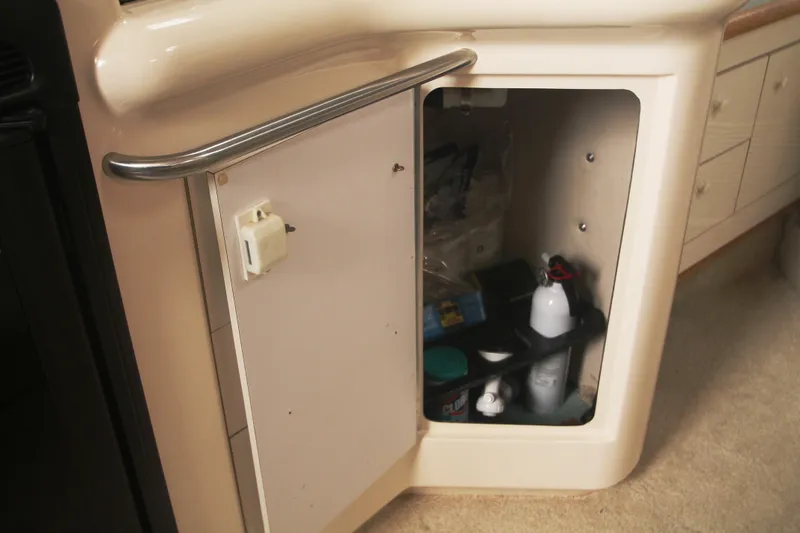 Slide: The Image of Open cabinet on 1996 Sea Ray Sundancer 330 boat, showing interior storage space. - 21