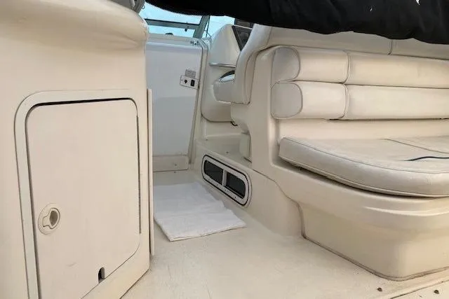 Slide: The Image of Interior of a 1996 Sea Ray Sundancer 330 boat, featuring white leather seating. - 24