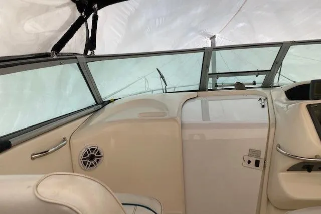 Slide: The Image of 1996 Sea Ray Sundancer 330 cockpit with windshield and seating area. - 25