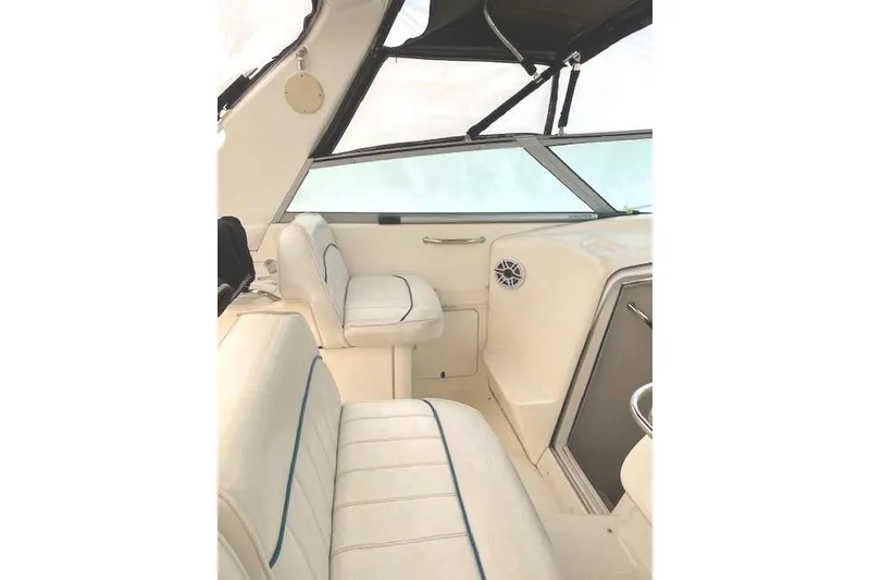 Slide: The Image of Interior of a 1996 Sea Ray Sundancer 330 boat with white seating and windows. - 26