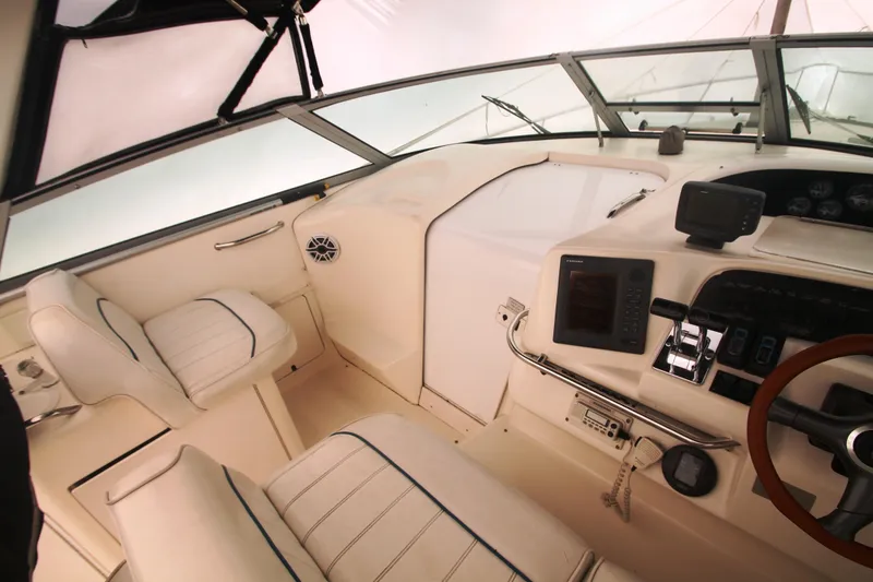 Slide: The Image of 1996 Sea Ray Sundancer 330 cockpit with steering wheel, navigation equipment, and seating. - 27