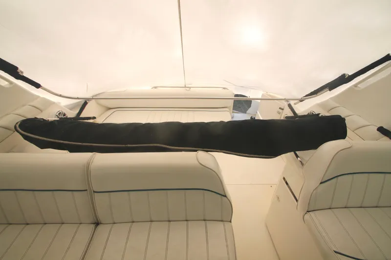 Slide: The Image of Interior of 1996 Sea Ray Sundancer 330 with white seating and covered equipment. - 31
