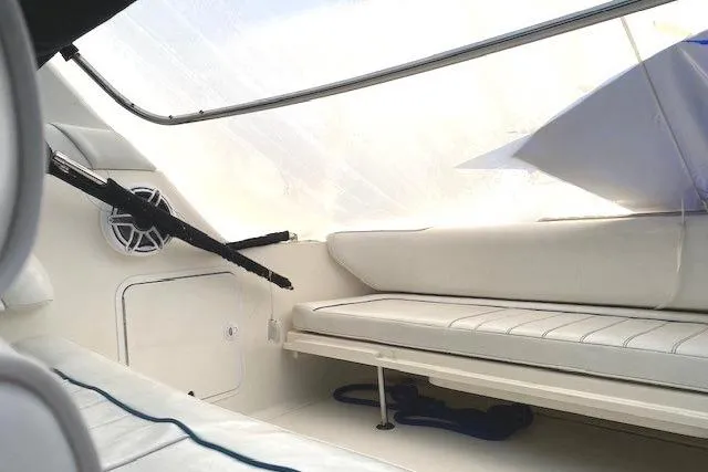 Slide: The Image of 1996 Sea Ray Sundancer 330 interior with white seating and speaker. - 32