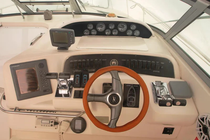 Slide: The Image of 1996 Sea Ray Sundancer 330 helm with gauges, controls, and navigation equipment. - 38