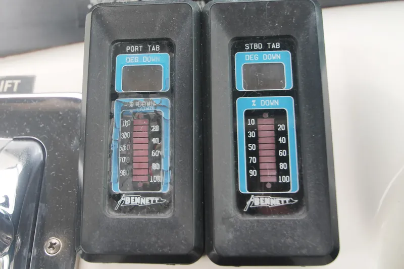 Slide: The Image of Bennett trim tab controls on a 1996 Sea Ray Sundancer 330 boat dashboard. - 43