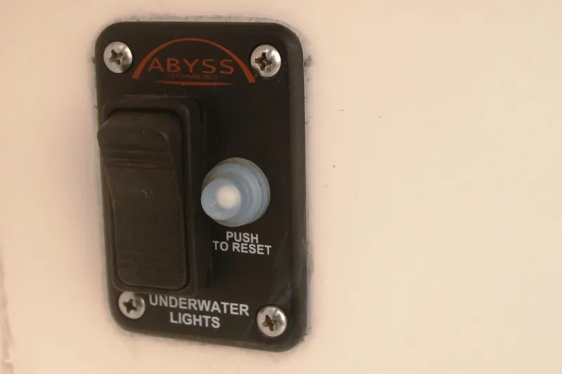 Slide: The Image of Underwater lights switch on 1996 Sea Ray Sundancer 330 boat, featuring reset button. - 49