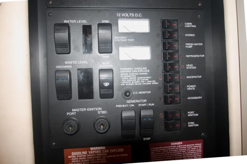 Slide: The Image of Control panel of a 1996 Sea Ray Sundancer 330 boat, featuring various switches and indicators. - 51