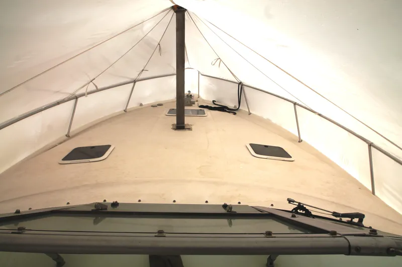 Slide: The Image of 1996 Sea Ray Sundancer 330 boat under protective cover, showing deck and hatches. - 53
