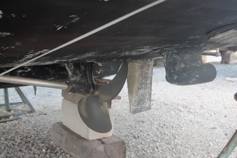 Slide: The Image of 1996 Sea Ray Sundancer 330 boat propeller and rudder on dry dock. - 57