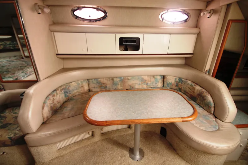 Slide: The Image of Interior of 1996 Sea Ray Sundancer 330 with cozy seating and table. - 6