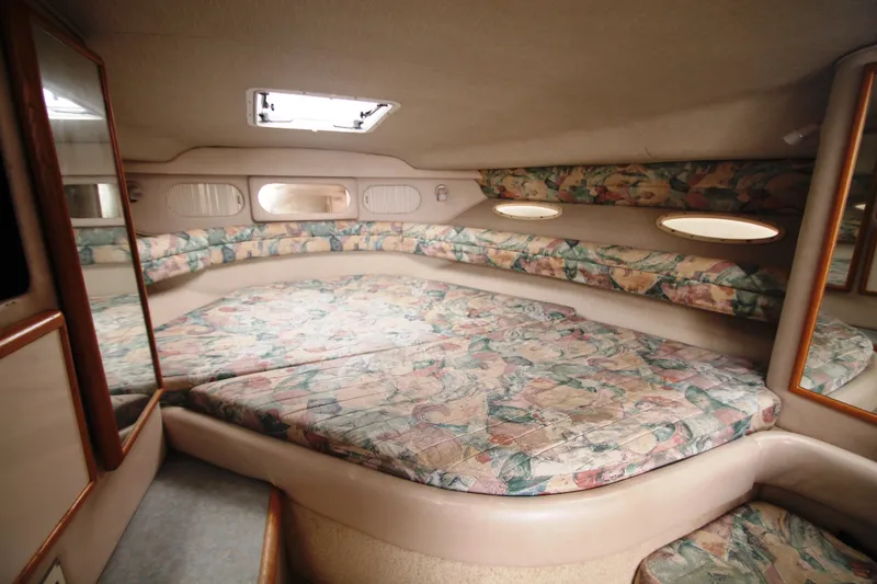 Slide: The Image of Interior cabin of 1996 Sea Ray Sundancer 330 with patterned upholstery and mirrors. - 8