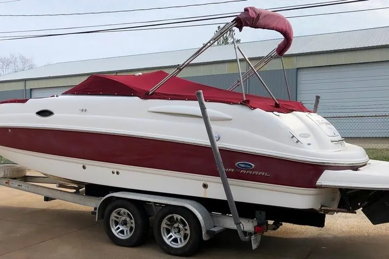 Slide: The Image of 2005 Chaparral Sunesta 254 boat on trailer, red and white design, parked outdoors. - 14