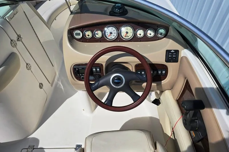 Slide: The Image of 2005 Chaparral Sunesta 254 boat dashboard with gauges and steering wheel. - 15