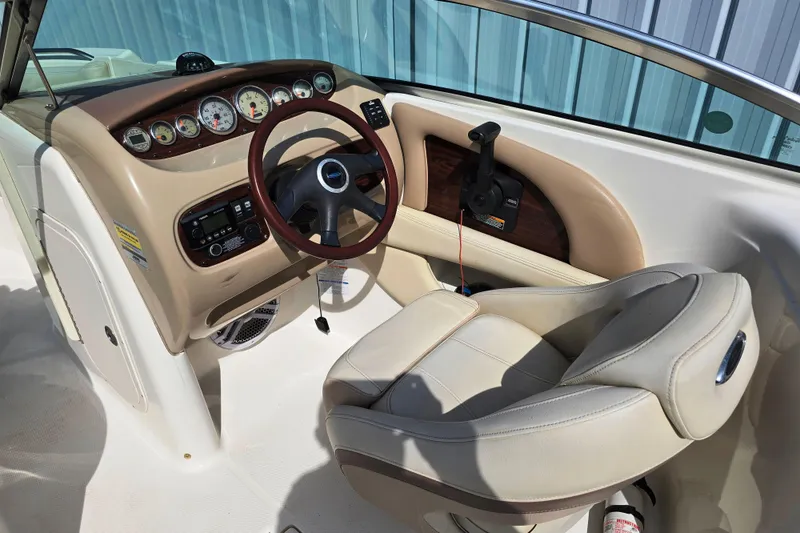 Slide: The Image of 2005 Chaparral Sunesta 254 boat cockpit with steering wheel and control panel. - 2