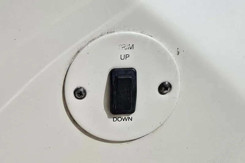 Slide: The Image of Trim control switch on 2005 Chaparral Sunesta 254 boat dashboard. - 26