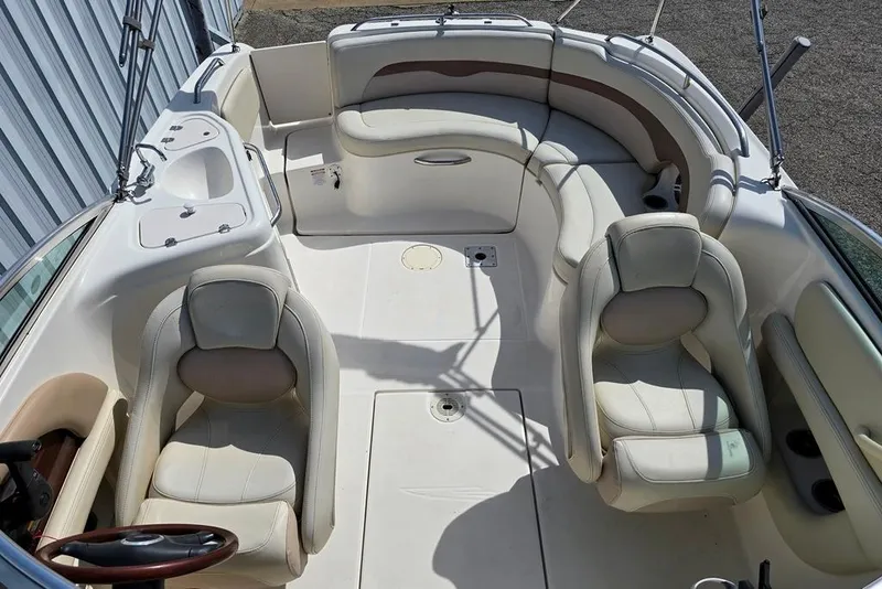 Slide: The Image of 2005 Chaparral Sunesta 254 boat interior with plush seating and steering wheel. - 4